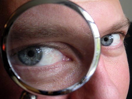 manlookingthroughmagnifyingglass_1.jpg